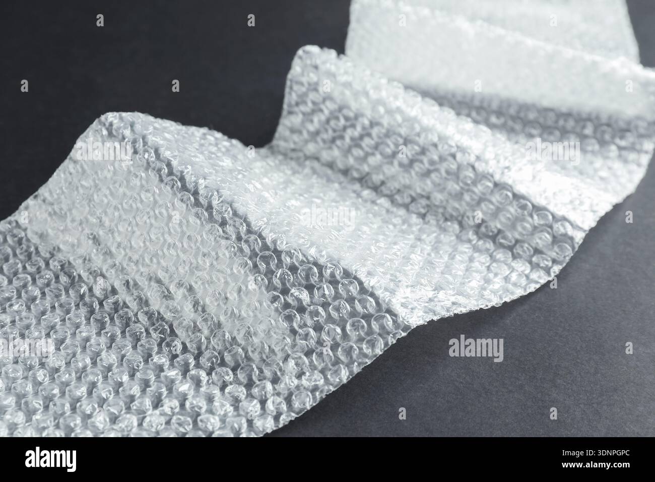Transparent bubble wrap on black background, closeup Stock Photo
