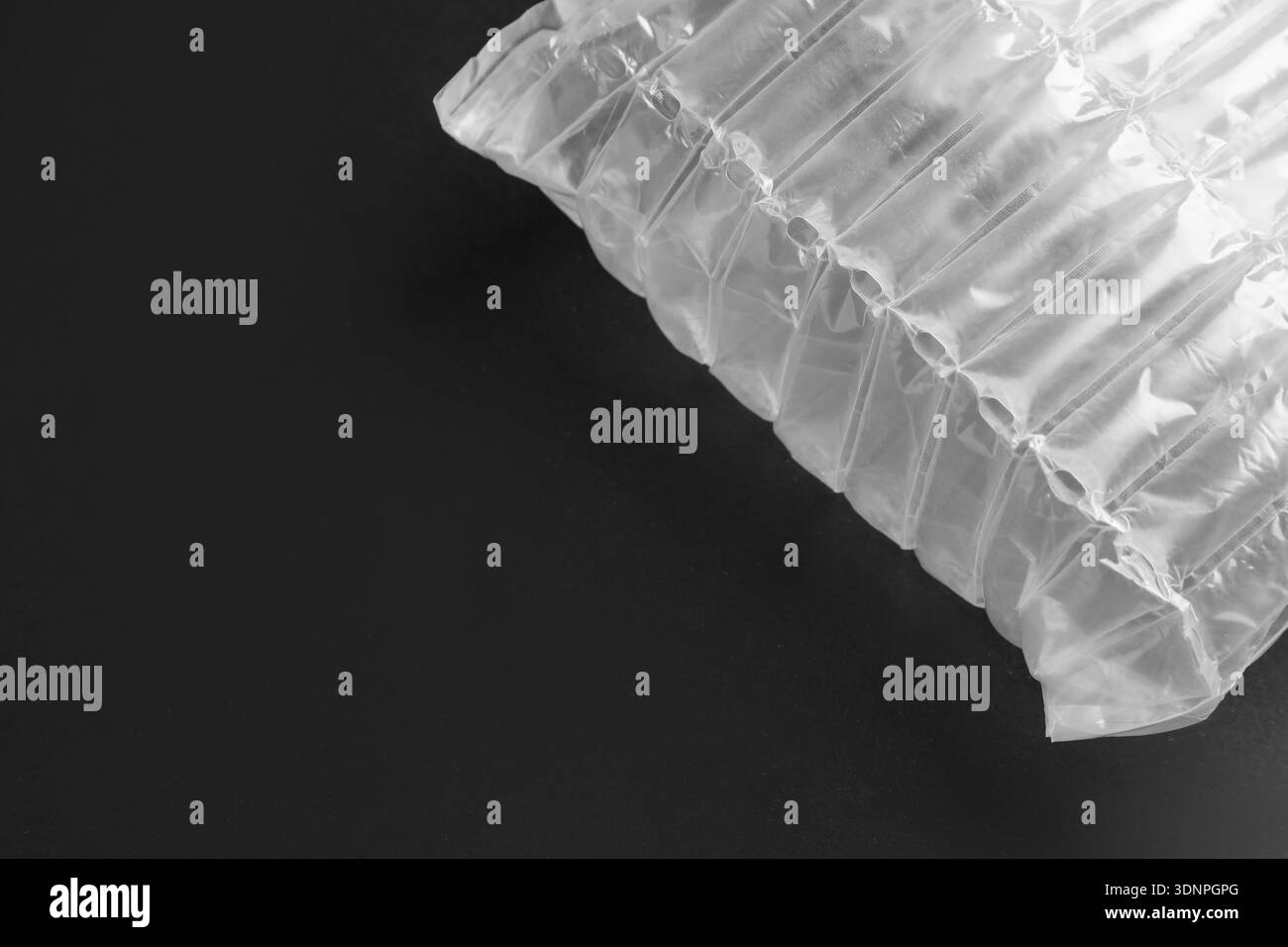 Transparent air buffer packaging on black background, top view. Space for text Stock Photo