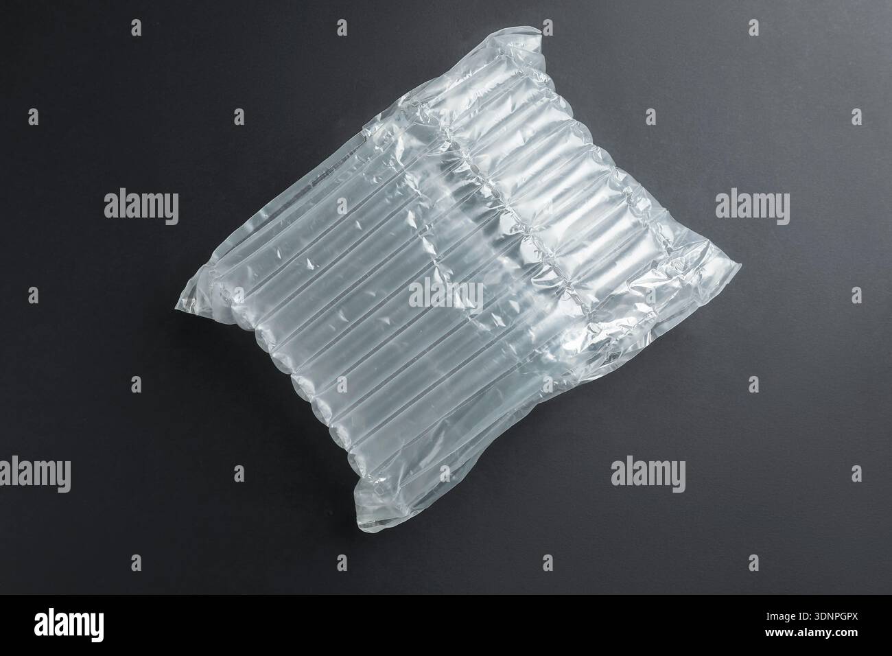 Transparent air buffer packaging on black background, top view Stock Photo