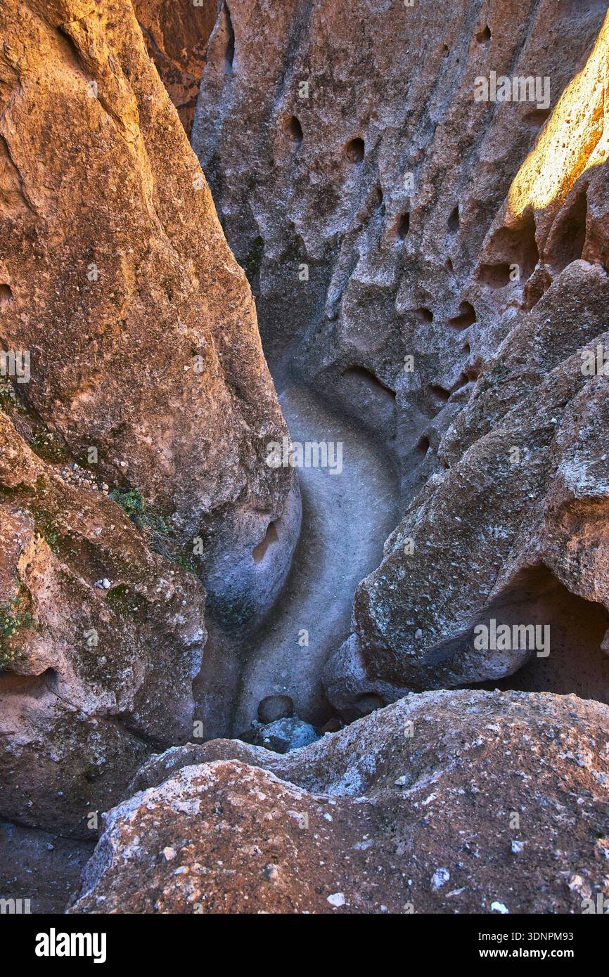 Desert Canyon Trail and Eroded Rock Formations with Sunlit Textures Stock Photo