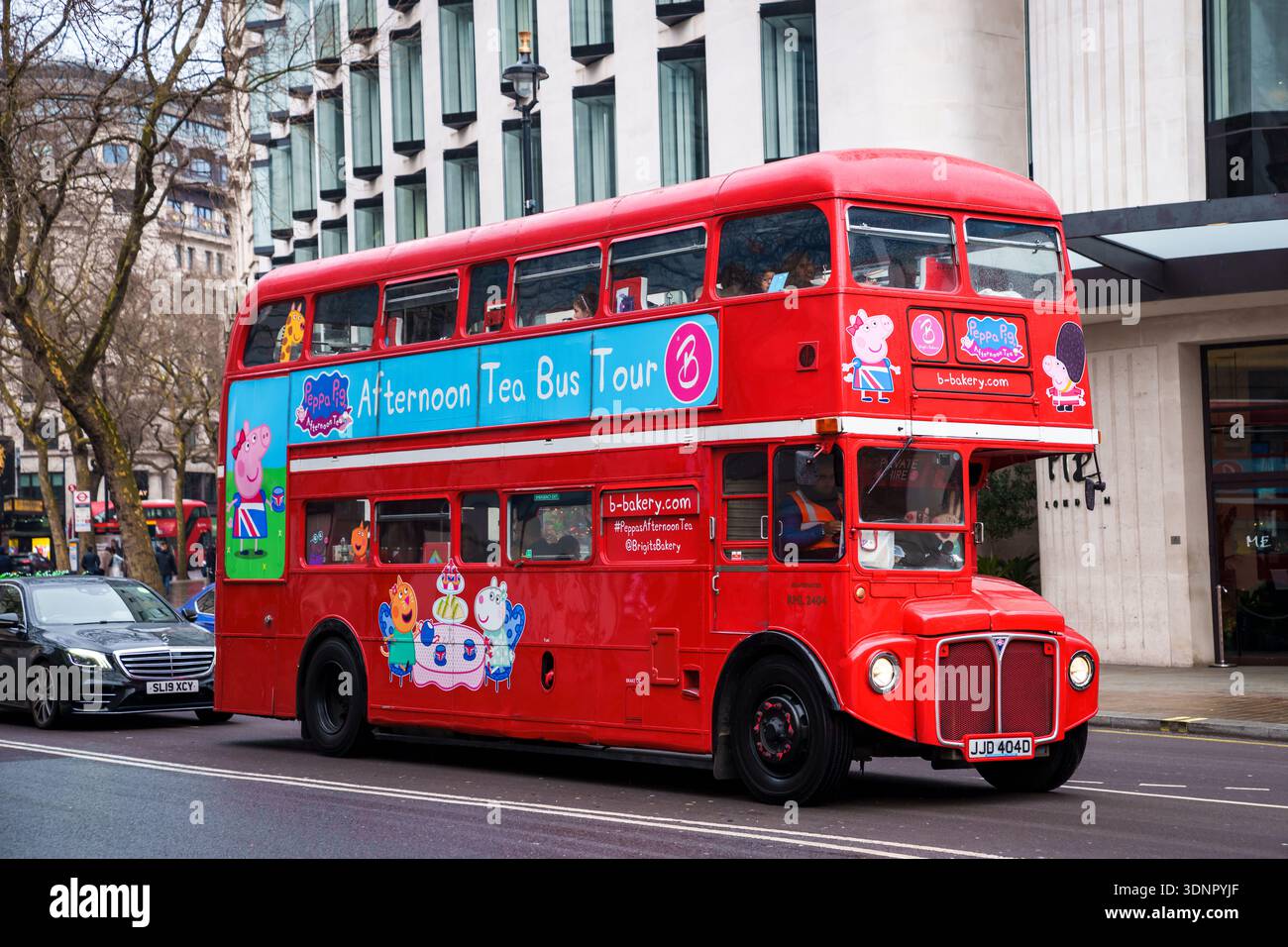LONDON, UK. 15th  February 2025. Iconic red double-decker buses in motion on a busy street in central London. Stock Photo