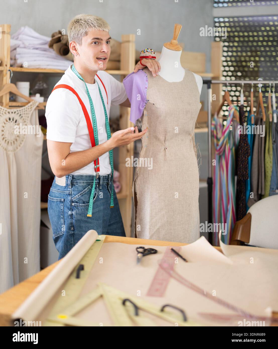 Young male tailor working with mannequin Stock Photo