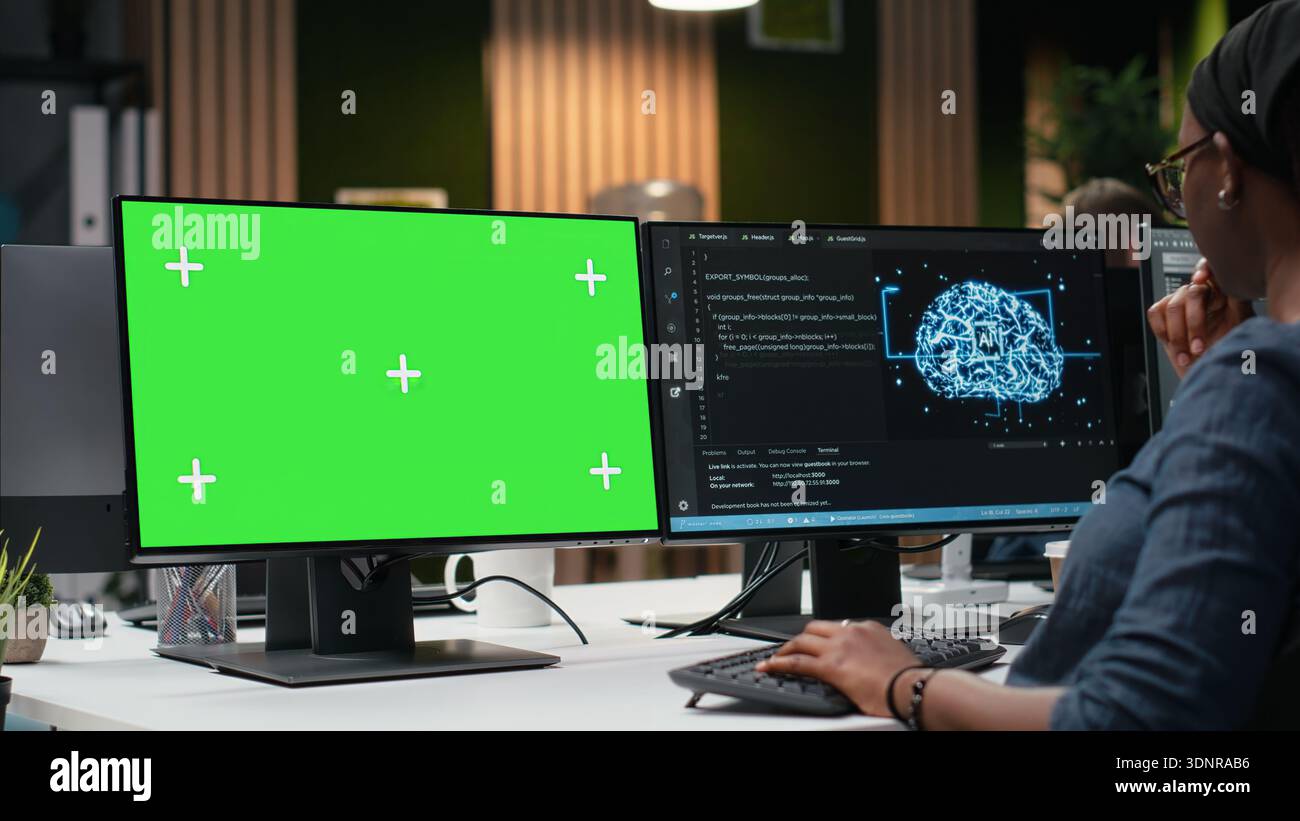 Green screen mockup computer used by programmer typing code, developing machine learning models to automate tasks. Developer writing programming language scripts on chroma key PC Stock Photo