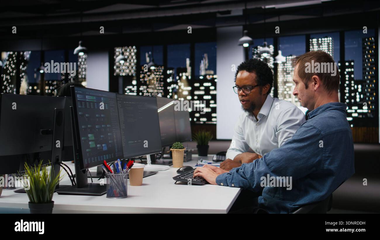 Engineering team in Silicon Valley company office developing apps with AI. Teamworking colleagues using machine learning to do coding, debugging applications to resolve issues Stock Photo