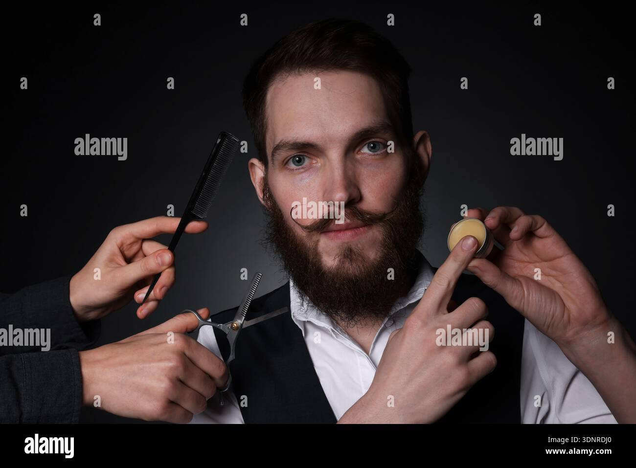 Man and barber with tools on black background Stock Photo