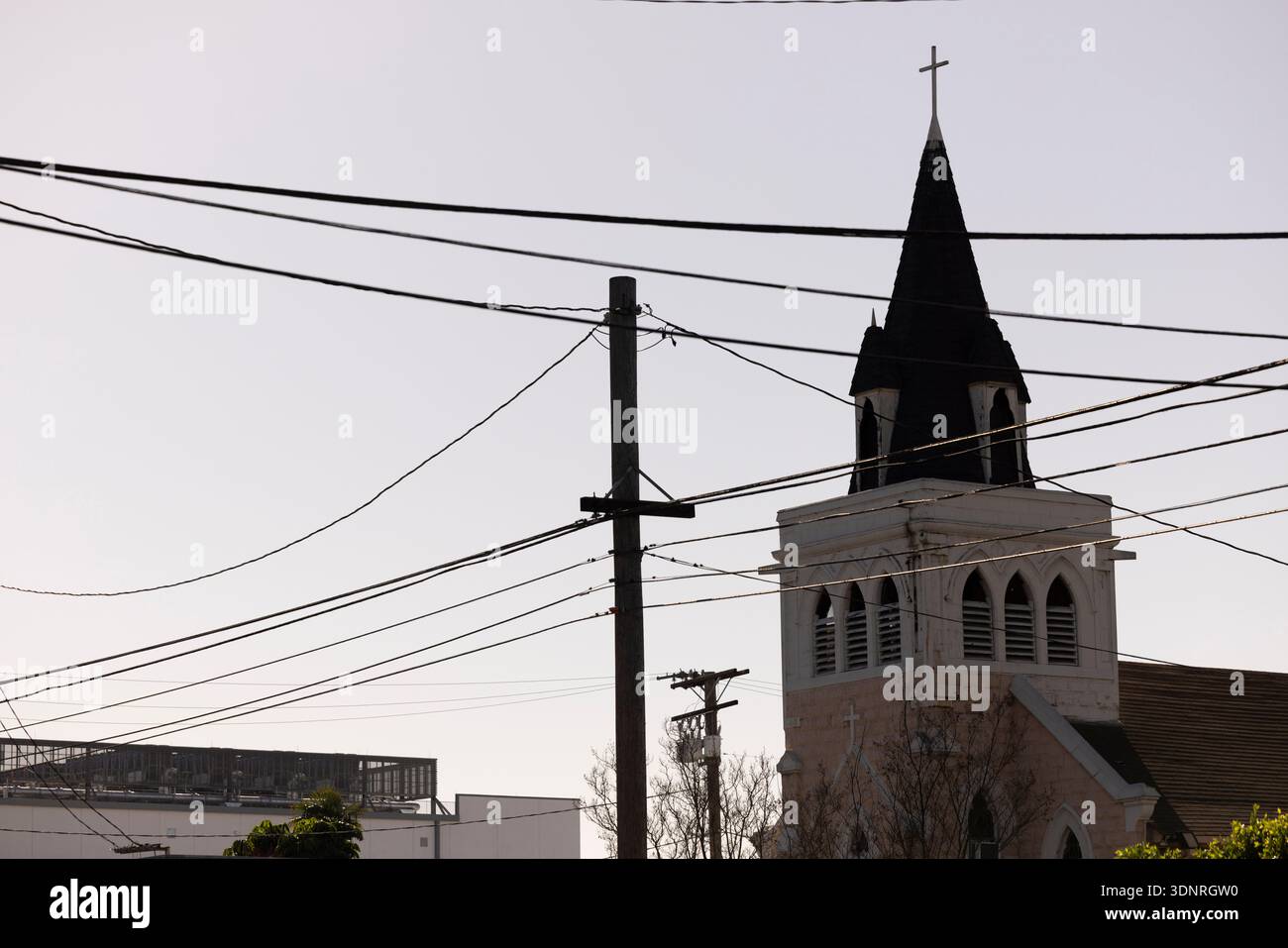 Afternoon sun shines on a historic church and surrounding cityscape of Vernon, California, USA. Stock Photo