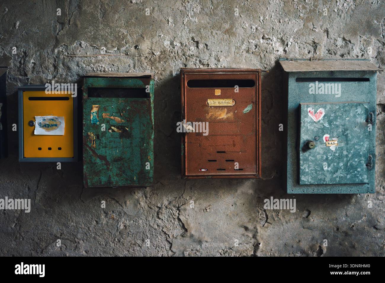 Old rusty mailbox on old dilapidated wall, close up detail. Stock Photo