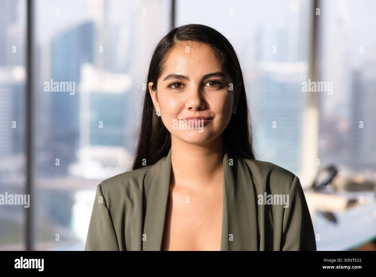 Positive beautiful Latin business leader woman posing for head shot Stock Photo