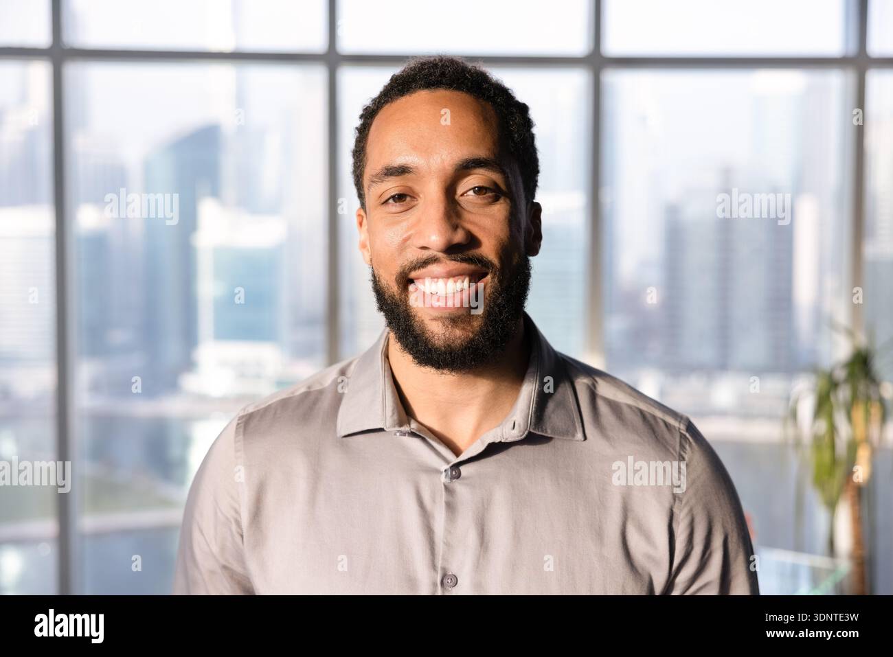 Happy handsome African American business leader man posing in office Stock Photo