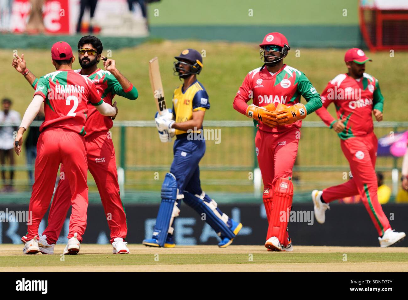 Oman's Jay Odedra, second left, celebrates with teammates the wicket of ...