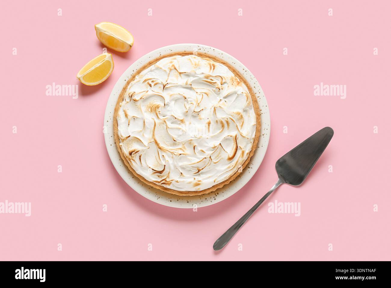 Plate with delicious lemon pie on pink table Stock Photo