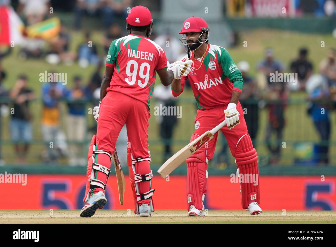 Oman's Mohammad Nadeem, left, congratulated by Oman's Jay Odedra after