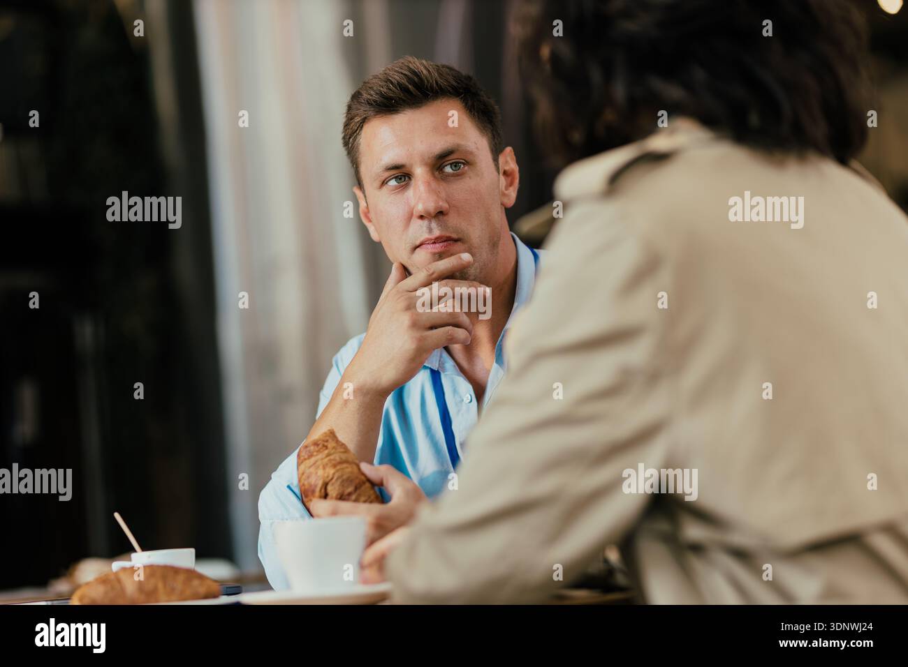 Business colleagues having coffee break discussing work Stock Photo