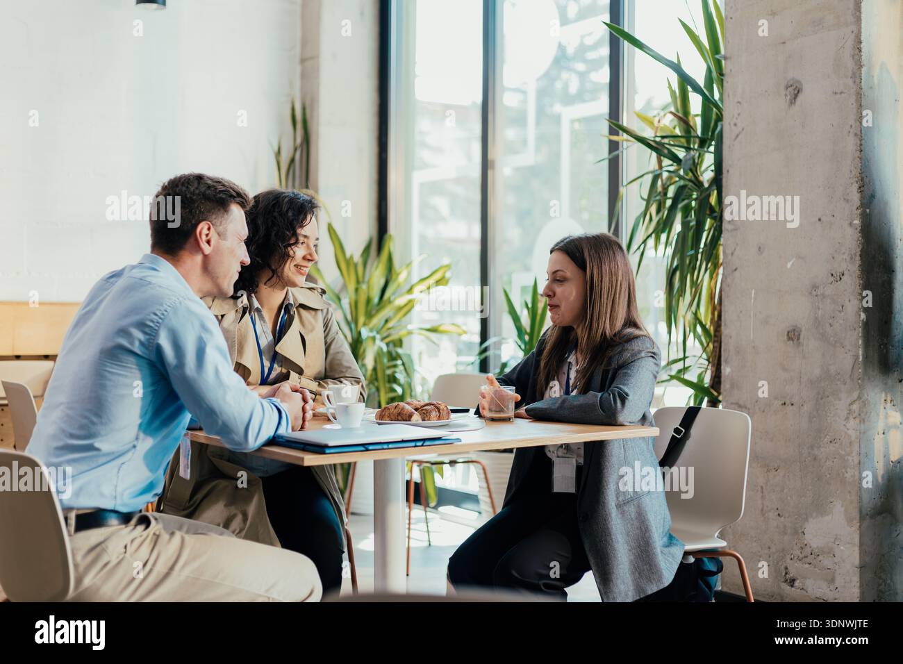 Business professionals discussing work at a coffee break Stock Photo