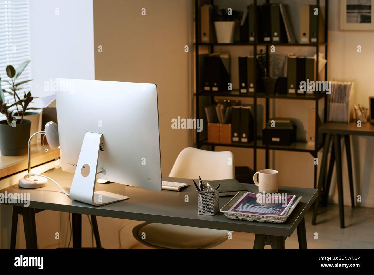 Modern Office Workspace Featuring Desktop Computer and Digital Tablet on Desk Stock Photo