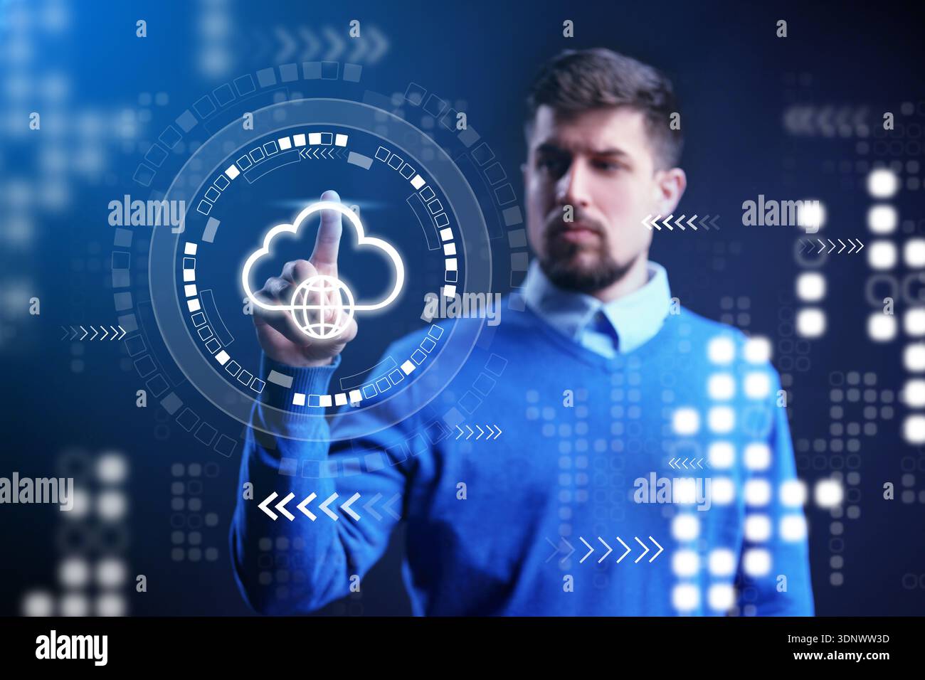 Man interacts with digital cloud interface in a modern workspace at evening time Stock Photo