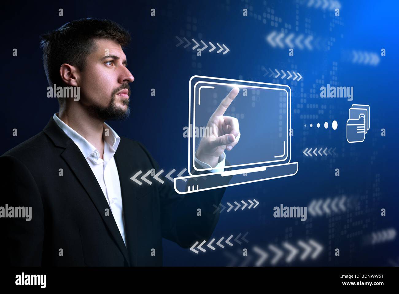 Man interacts with holographic laptop display in modern tech environment Stock Photo