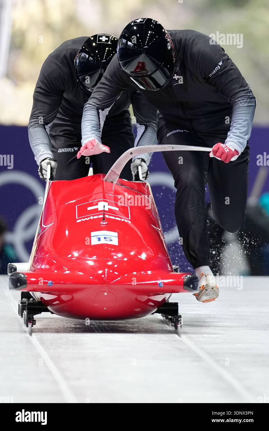Switzerland's Michael Vogt, right, starts for a two man bobsled ...