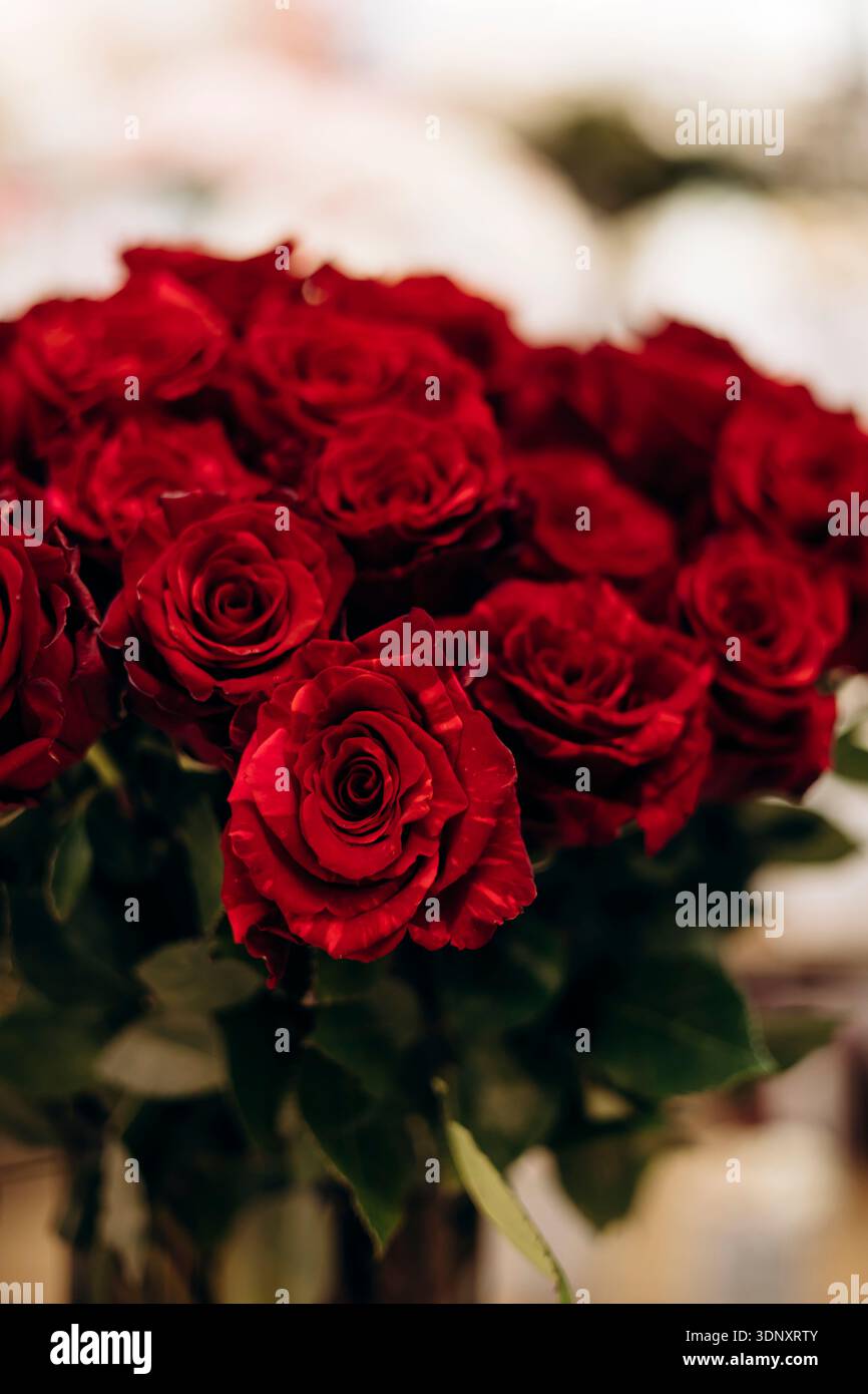 A stunning bouquet of vibrant red roses displayed in a floral shop ...
