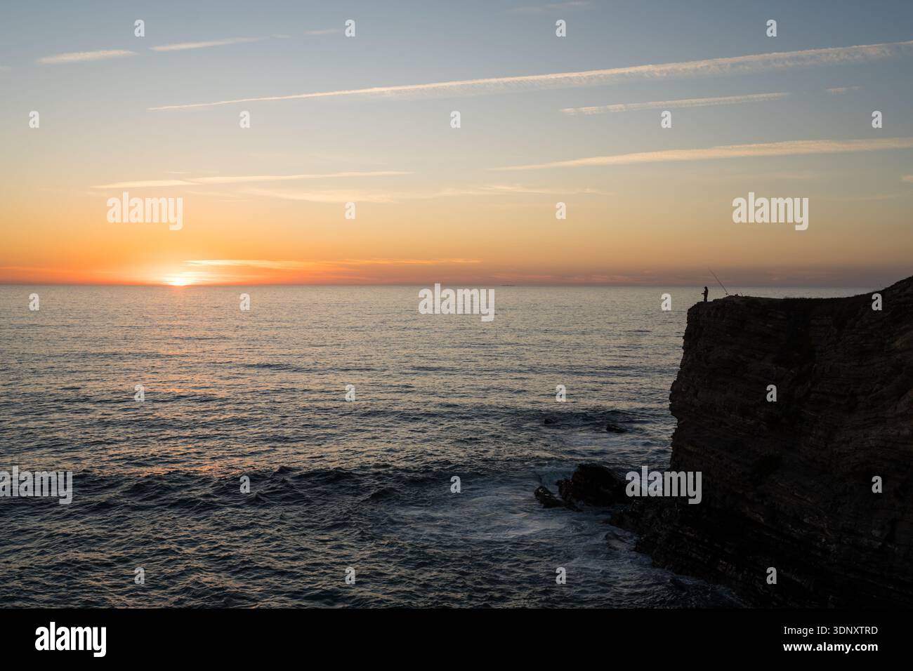 A Breathtaking Sunset Over The Ocean At Zambujeira Do Mar Portugal a-breathtaking-sunset-over-the-ocean-at-zambujeira-do-mar-portugal