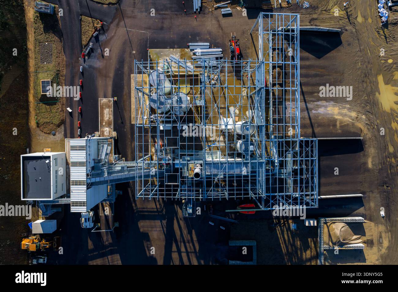 Aerial view of a metal framework structure casting long shadows across ...