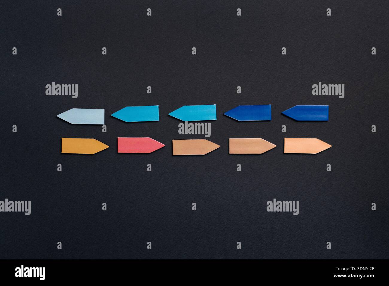 Minimal conceptual image with colorful arrow shapes arranged in ...