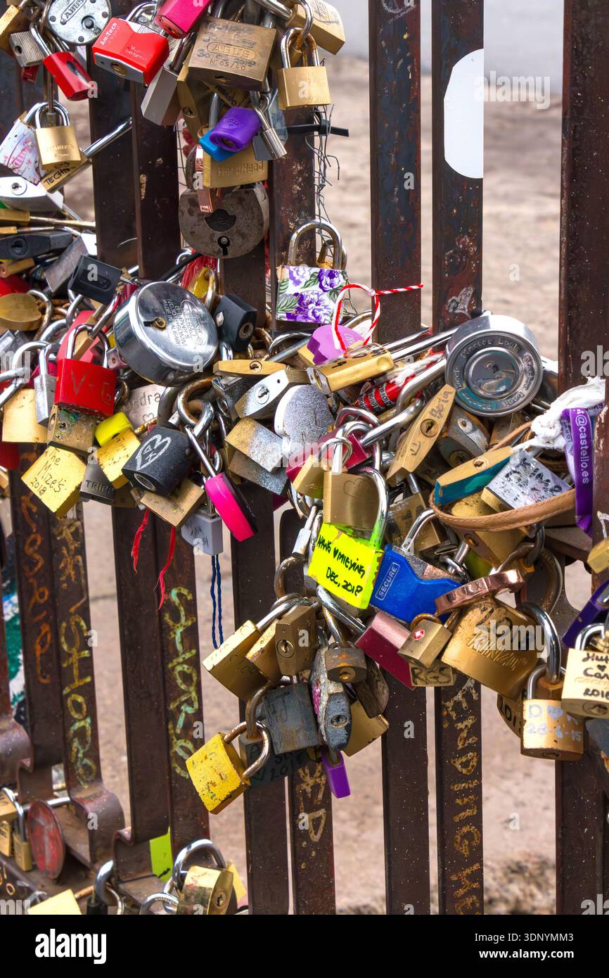 Close up of many assorted colorful love locks attached tightly to a metal railing structure. love and commitment Stock Photo