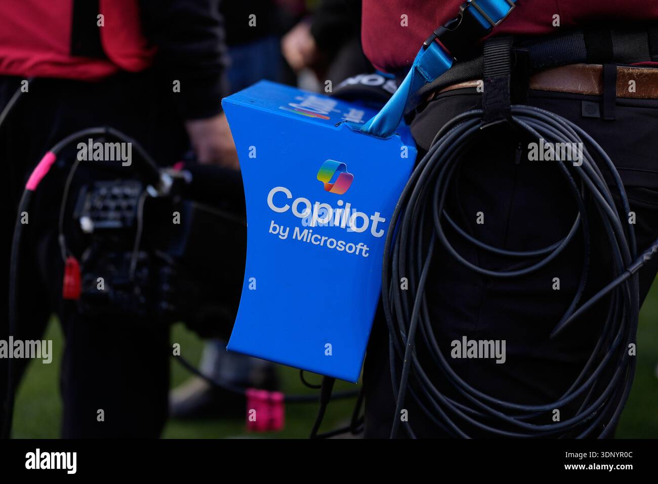 A Microsoft Surface tablet is held on the sideline before the NFL Super
