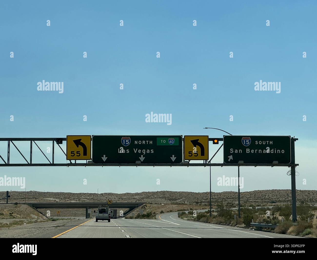Highway sign for I-15 toward Las Vegas and I-40 in desert landscape, USA. - Smartphone Captured Stock Image