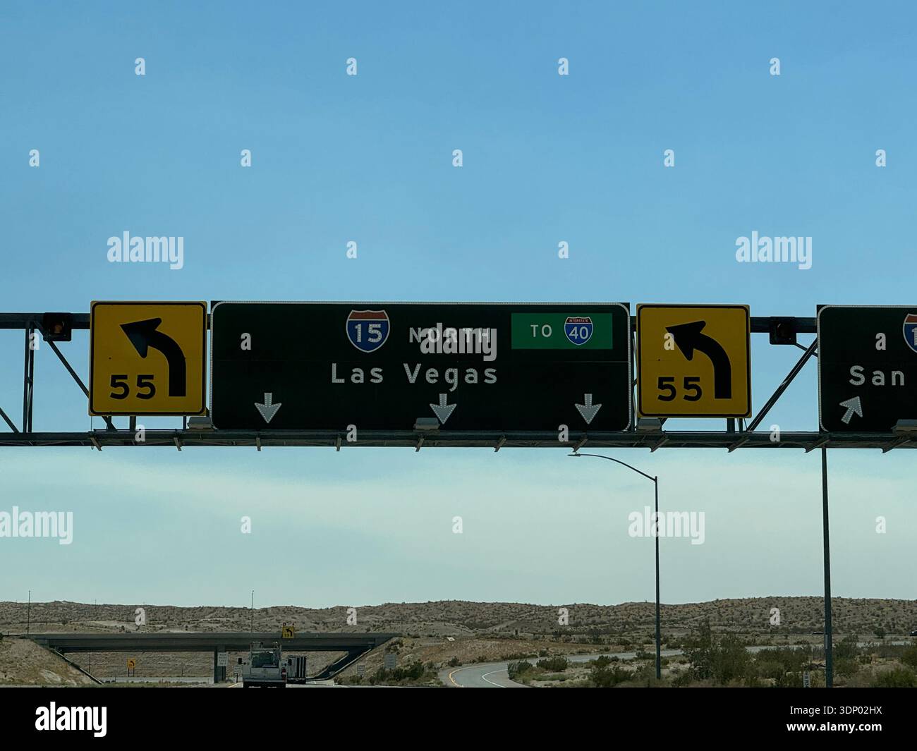 Highway sign for I-15 toward Las Vegas and I-40 in desert landscape, USA. - Smartphone Captured Stock Image