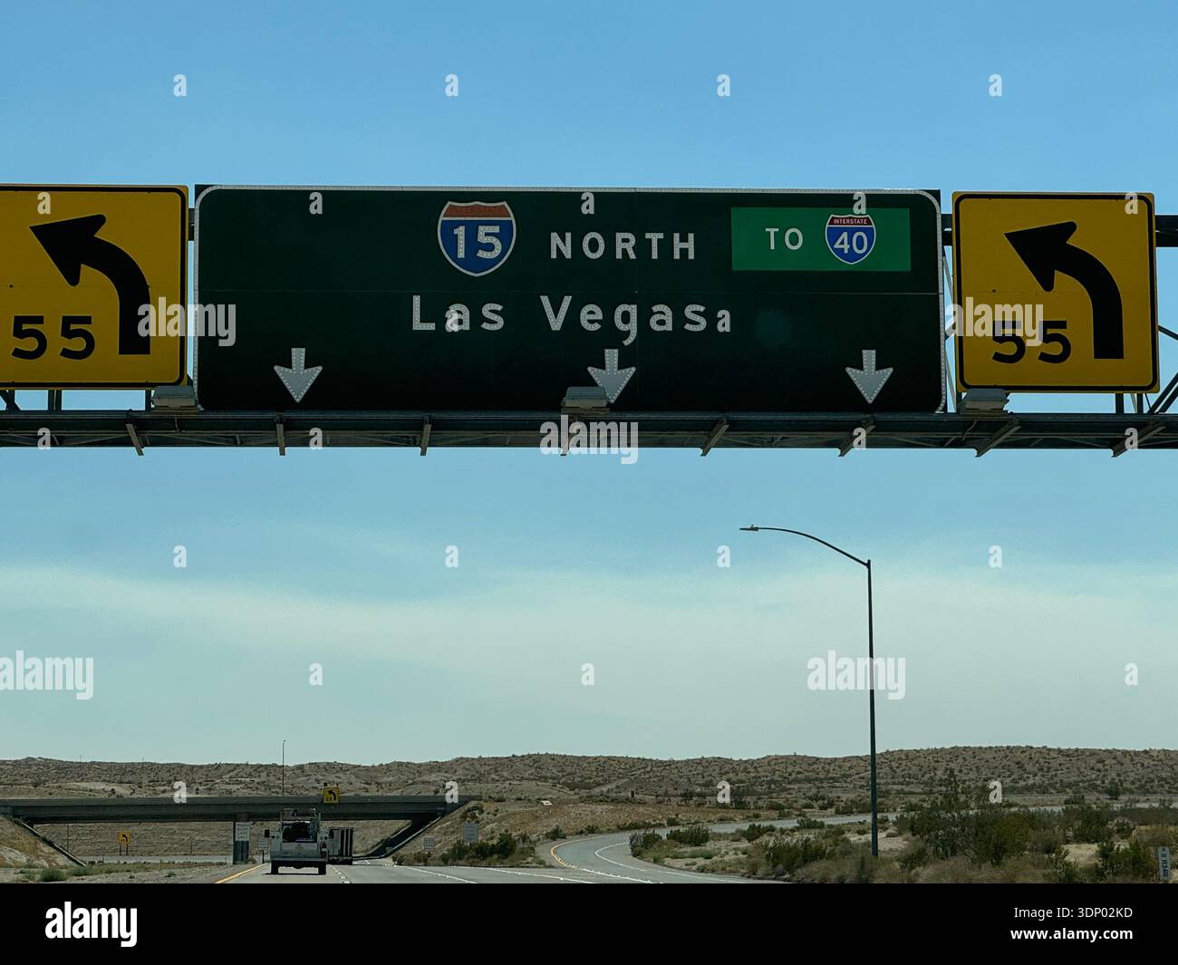 Highway sign for I-15 toward Las Vegas and I-40 in desert landscape, USA. - Smartphone Captured Stock Image