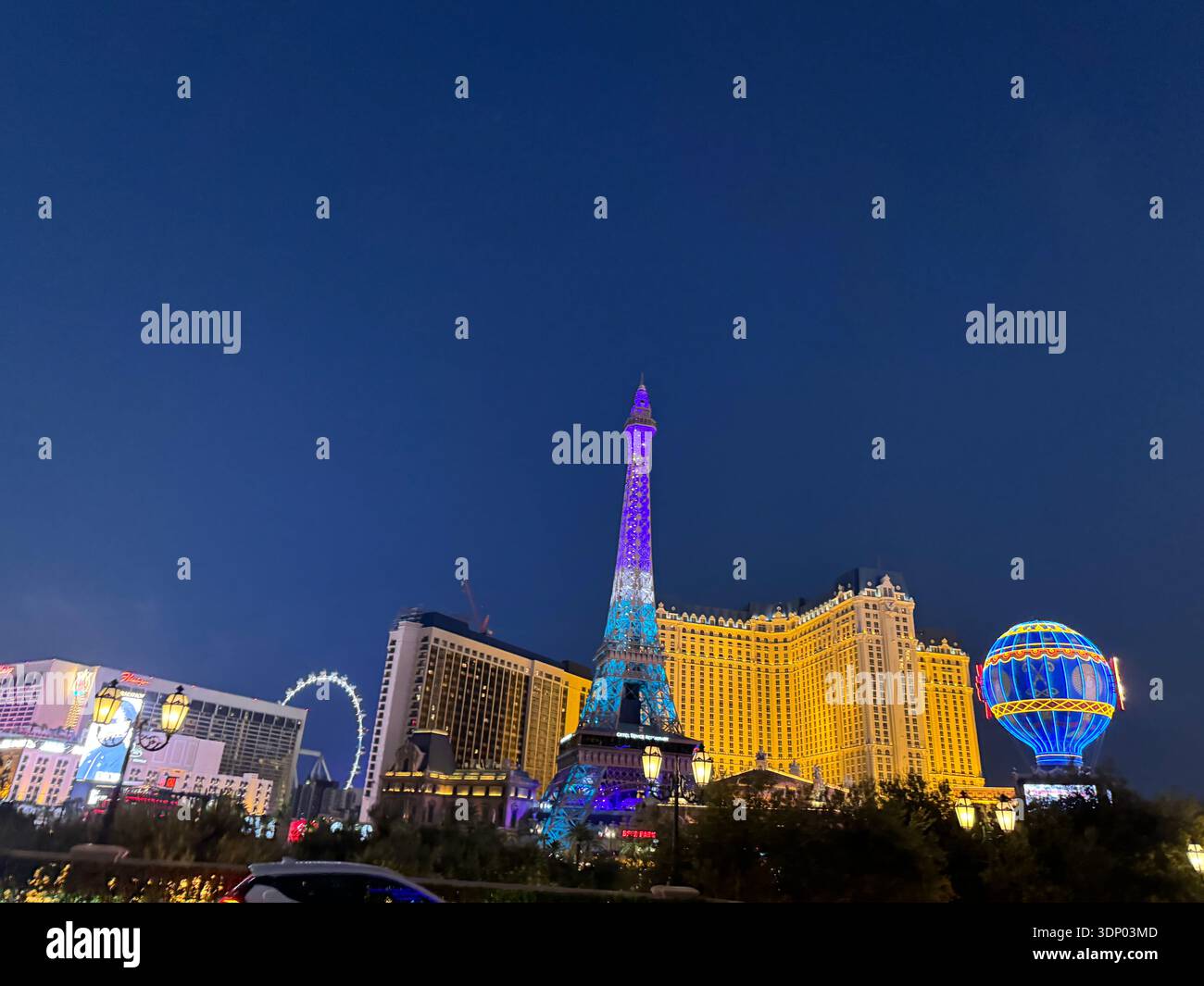 Las Vegas Strip skyline at night with Paris Las Vegas Eiffel Tower replica and Paris Balloon illuminated, famous hotels and casinos on Las Vegas Boule - Smartphone Captured Stock Image