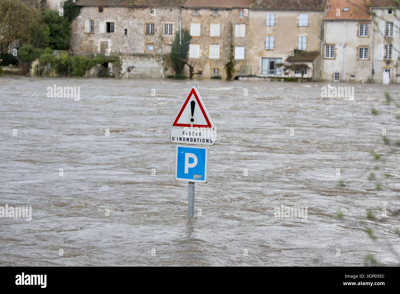 A flooded road with a sign reading "risk of flooding" is seen in ...