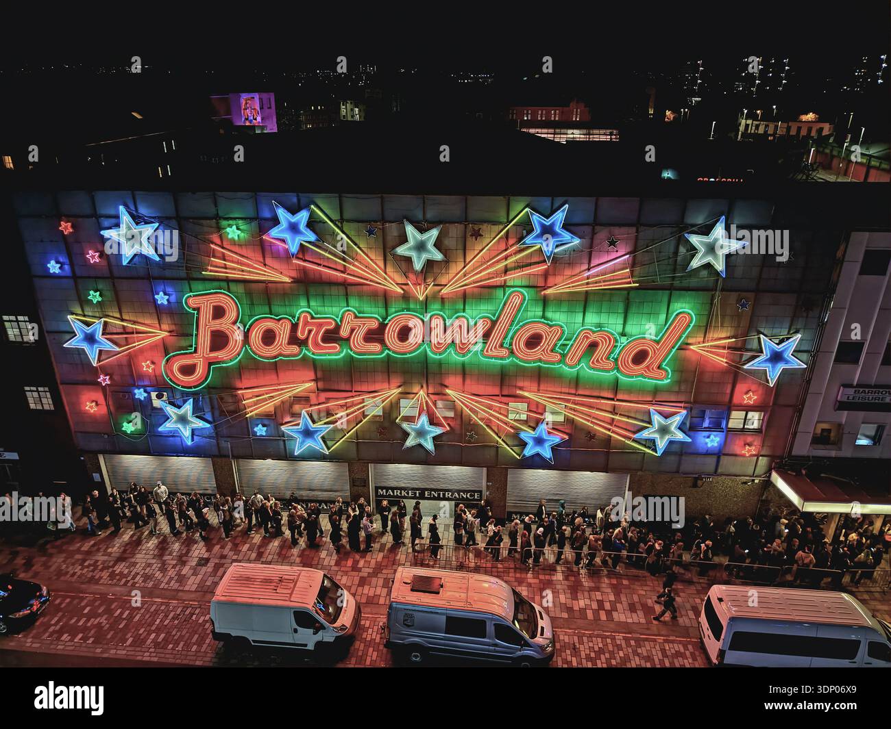 Crowds gathered outside the Barrowland Ballroom at night in Glasgow, Scotland, with illuminated neon signage on the famous music venue façade. Stock Photo