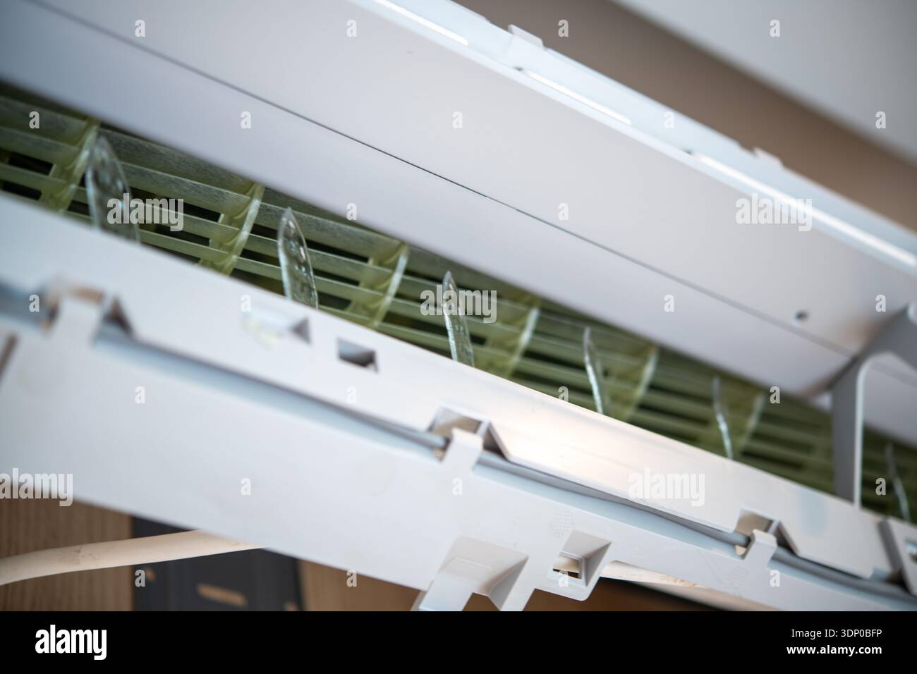 A closeup view of a white domestic air conditioner unit mounted on an ...