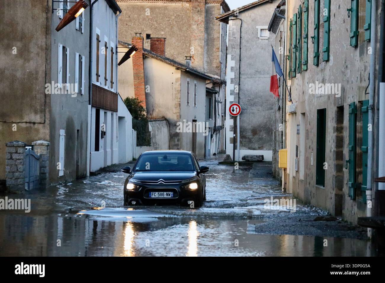 A car drives through a flooded street of Saint-Germain de Confolens as ...