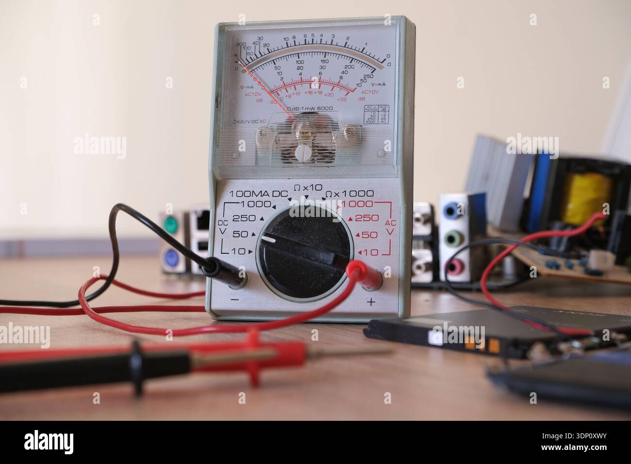 Electronics repair and restoration workbench with analog multi meter. Stock Photo