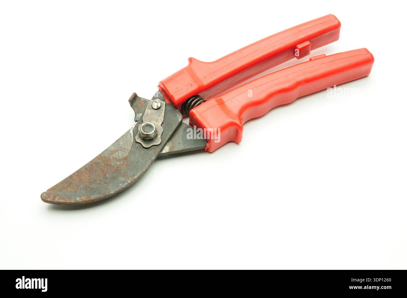 Red scissors for pruning tree branches and bushes on isolated white background Stock Photo