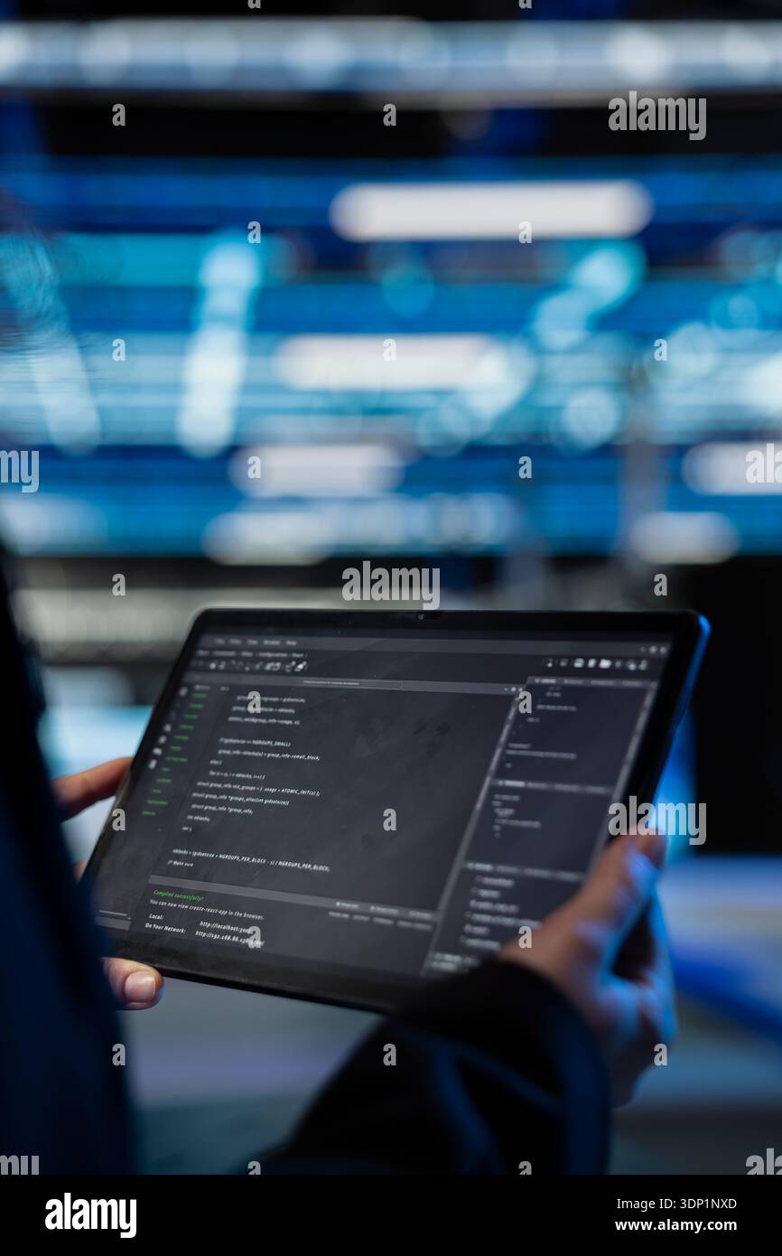 Writing code, tablet closeup and computer scientist in data center updating infrastructure network systems. Coding upgrades and worker typing on touchscreen device in server hub Stock Photo
