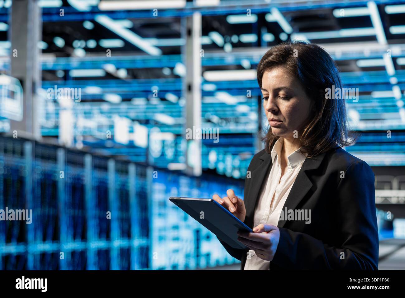 Infrastructure checkup, tablet and technician in data center, doing on computing, VFX compositing overlay. Device, server room employee, walking between blue wireframe mainframes Stock Photo