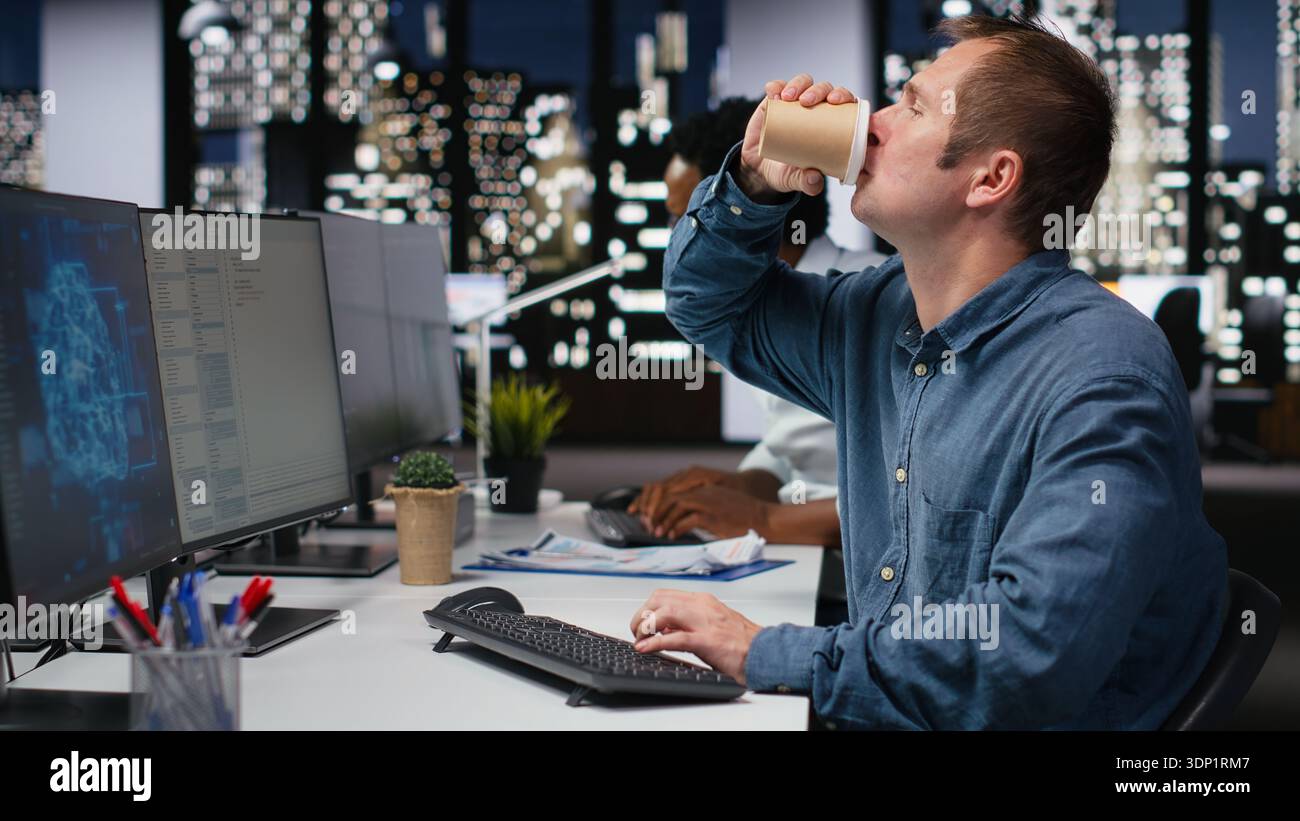 Tech startup worker drinking coffee, developing AI algorithms in high rise office. Caffeinated programmer energetically debugging neural network brain models on screens Stock Photo