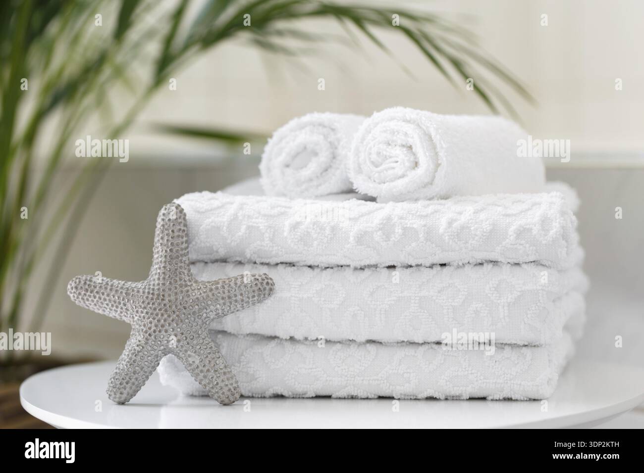 Rolled white towels in the bathroom or a spa salon, close up Stock Photo