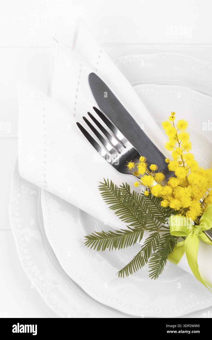Spring table setting with mimosa easter holidays dinner Stock Photo