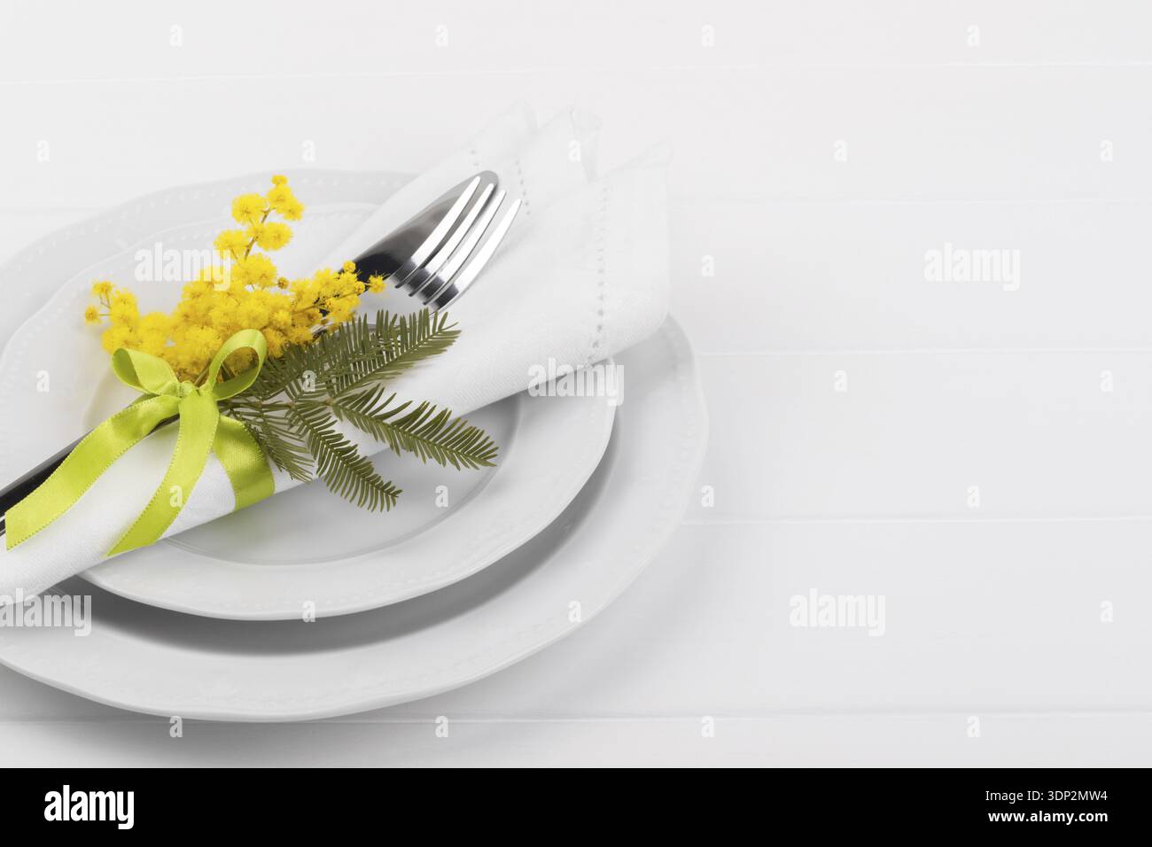 Spring table setting with mimosa easter holidays dinner Stock Photo