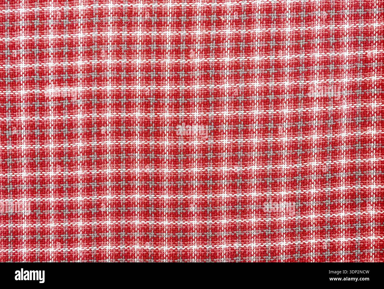 Woven wool fabric as a creative backdrop. Wool fabric texture. Threads texture as background in red Stock Photo