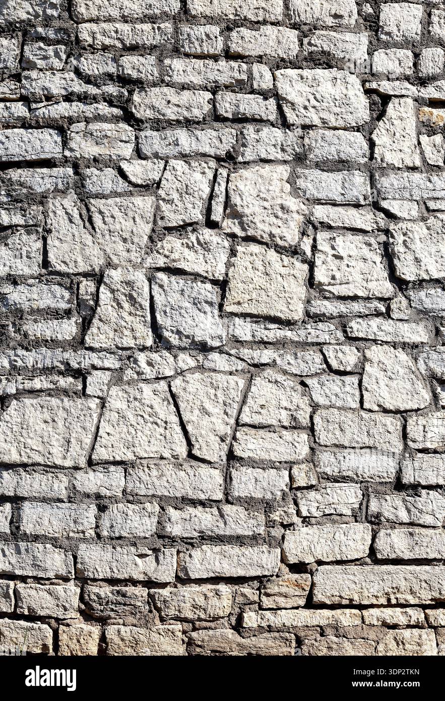 Ancient weathered rough stone wall as creative background. Grunge brick wall texture background Stock Photo