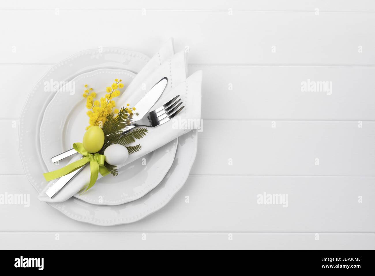 Spring table setting with mimosa easter holidays dinner Stock Photo