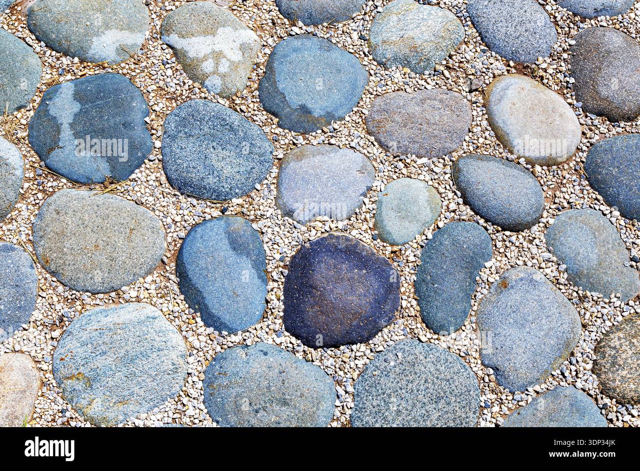 Cobblestone pavement on the road as creative background texture Stock Photo