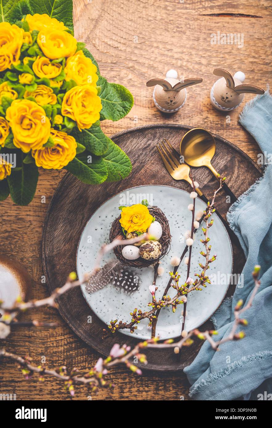 Overhead view of an Easter place setting with Easter eggs and flowers Stock Photo