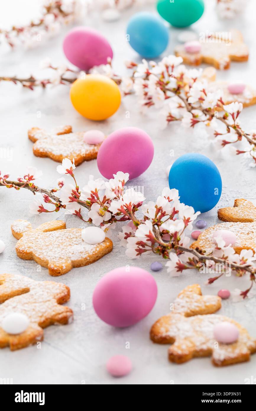 Easter bunny almond cookies and Easter eggs on decorated festive table Stock Photo